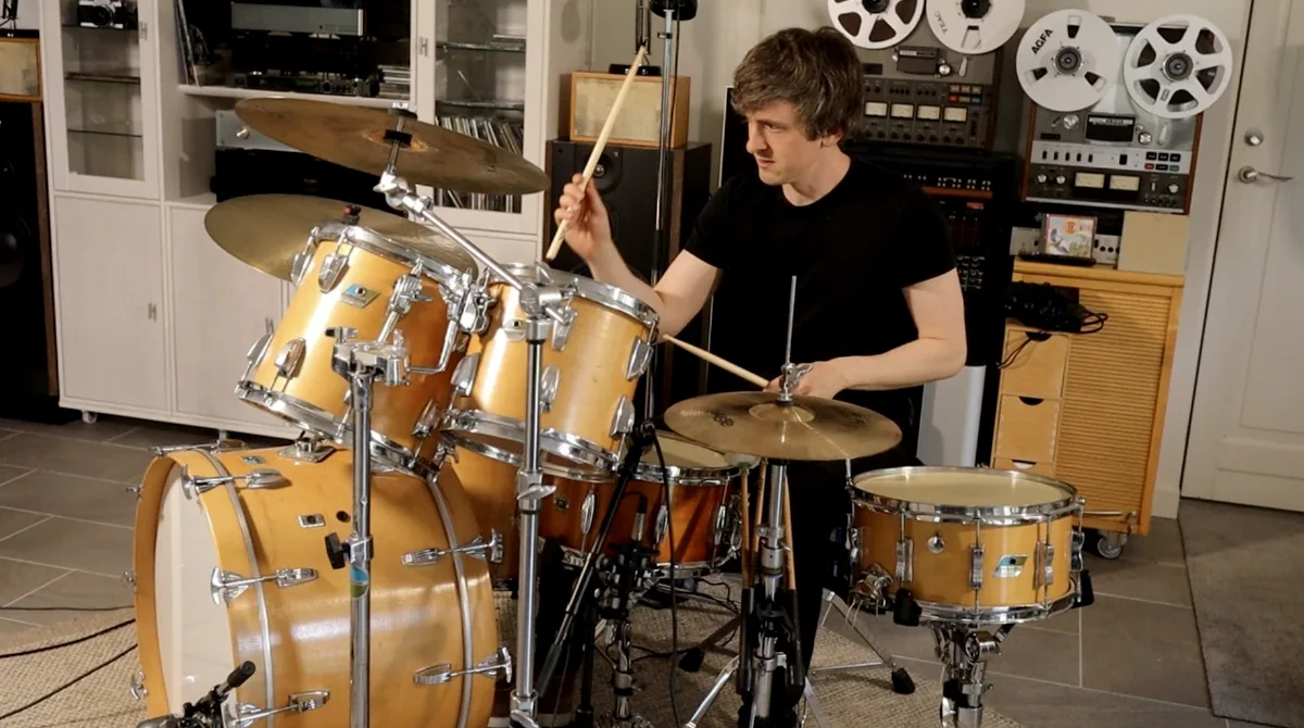 Mikas playing the seventies Ludwig kit in Lifebeat Studio, mid-stroke, with the drums miked up and tape machines on the wall behind him
